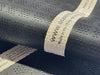 Close-up of the blue Atlantic Mats May Morris Tulip Ocean Mat with a white fabric label.