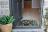 Atlantic Mats May Morris Tulip Green Curious Collection doormat at an open doorway
