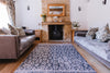Atlantic Mats Antiqued Caption recycled rug in a cozy living room with a stone fireplace