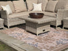 Atlantic Mats Gold Rose recycled rug in an outdoor patio setting with wicker furniture