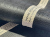 Close-up of a navy blue Atlantic Mats recycled washable doormat showing the fabric texture and label.