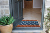 Atlantic Mats Woodblock Paisley Curious Collection Ocean Mat in a home doorway